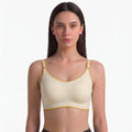 Model wearing Wireless Comfort Bra in cream with gold trim – front view